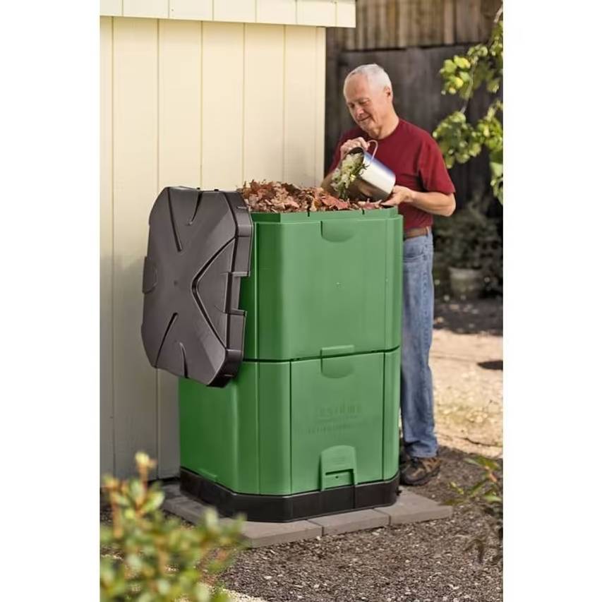 Man filling 400 litre aerobin hot composter in Brunswick green