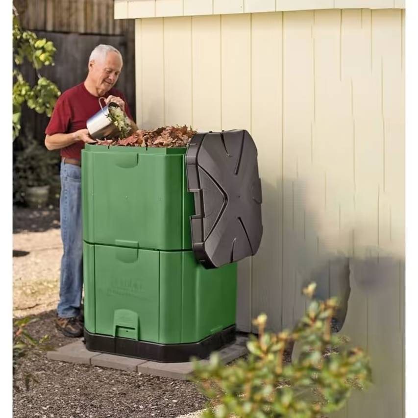 Man filling Brunswick green aerobin hot composter 400 litres