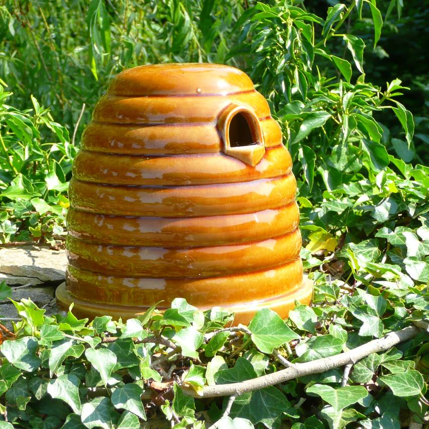 Ceramic bumblebee nest box surrounded by ivy