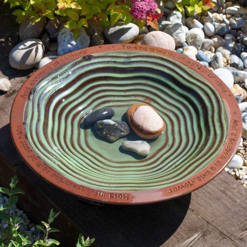 Echoes glazed bird bath with pebbles