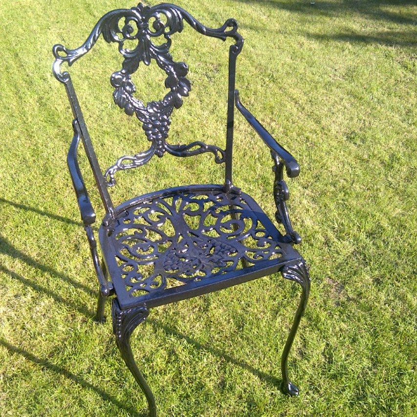 Jardine Leisure Grape carver chair in satin black finish standing on lawn in sunlight