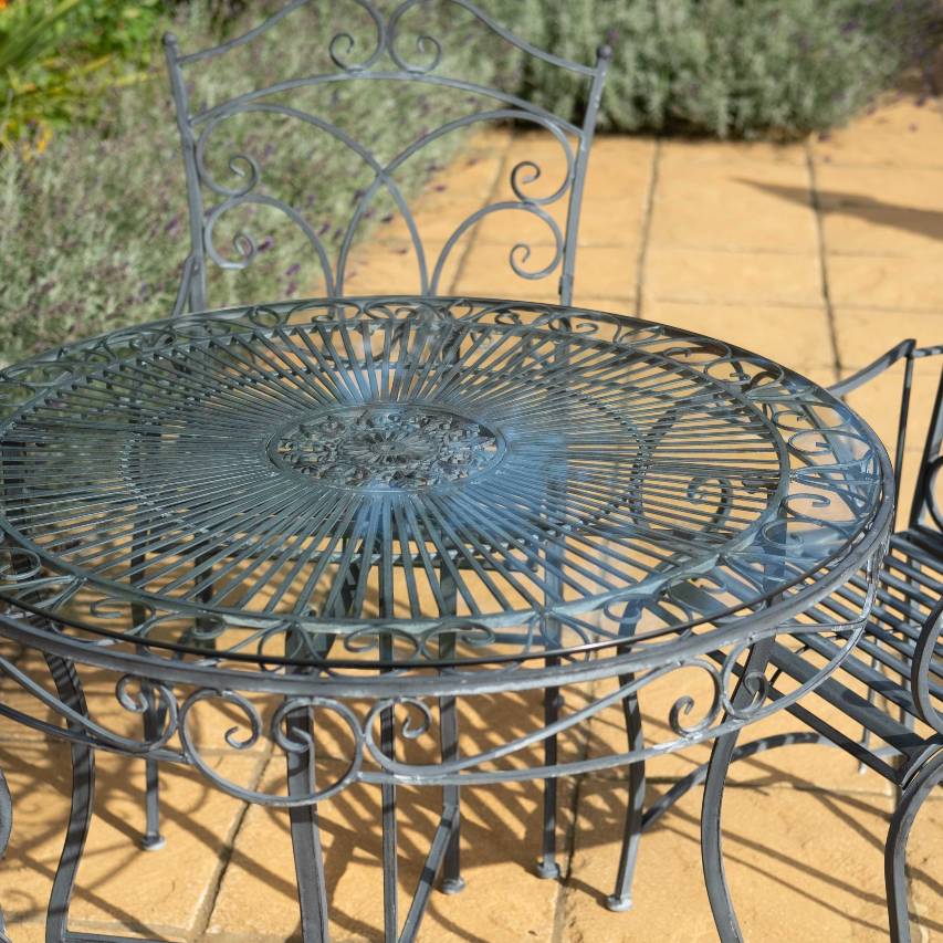 Heritage 5-piece bistro set with a dark lead frame and glass-top table.