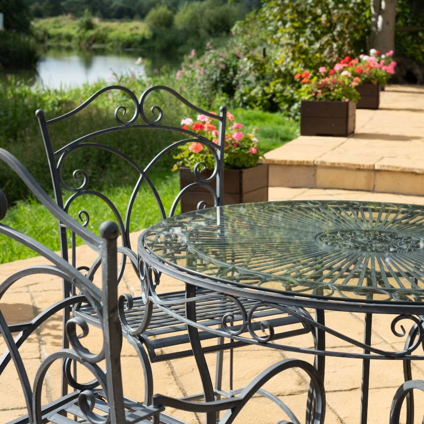 Close up of Heritage 5-piece bistro set with patio and river in background.