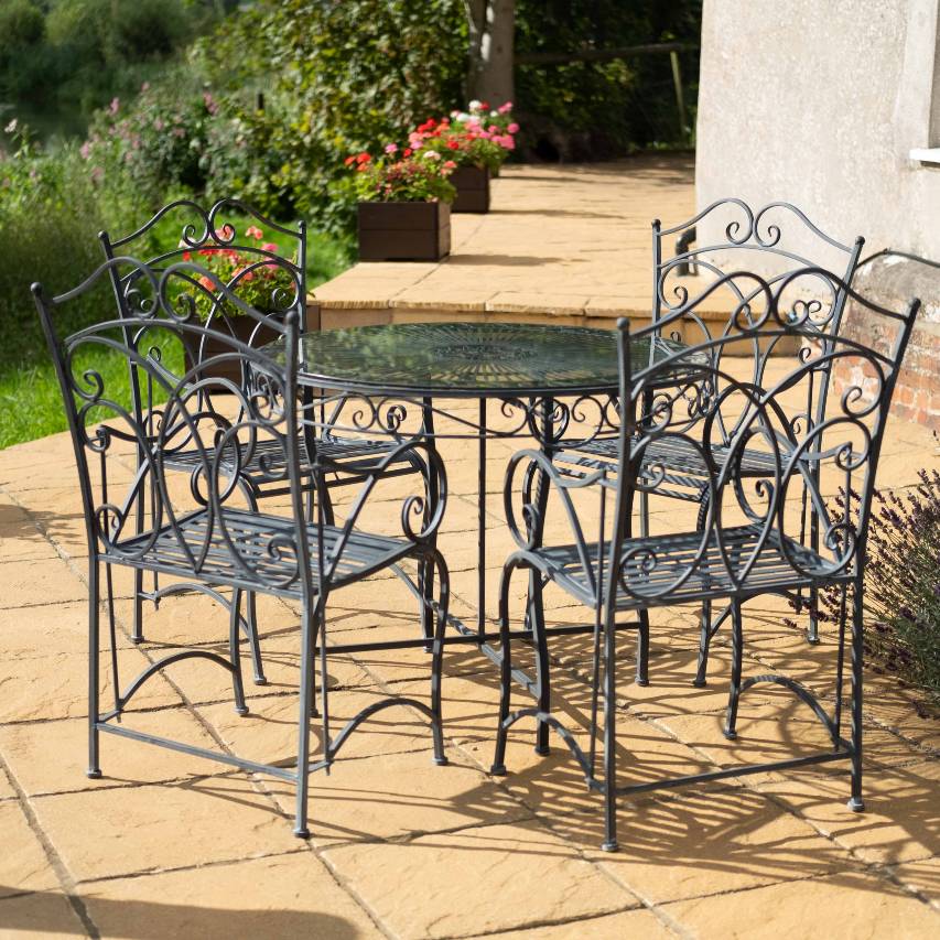 Heritage 5 piece bistro set in dark lead standing on patio next to lavendar