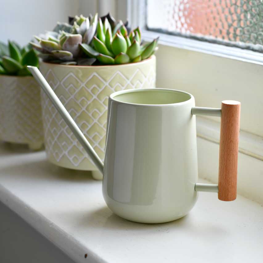 Burgon and Ball indoor watering can in pale jade on windowsill