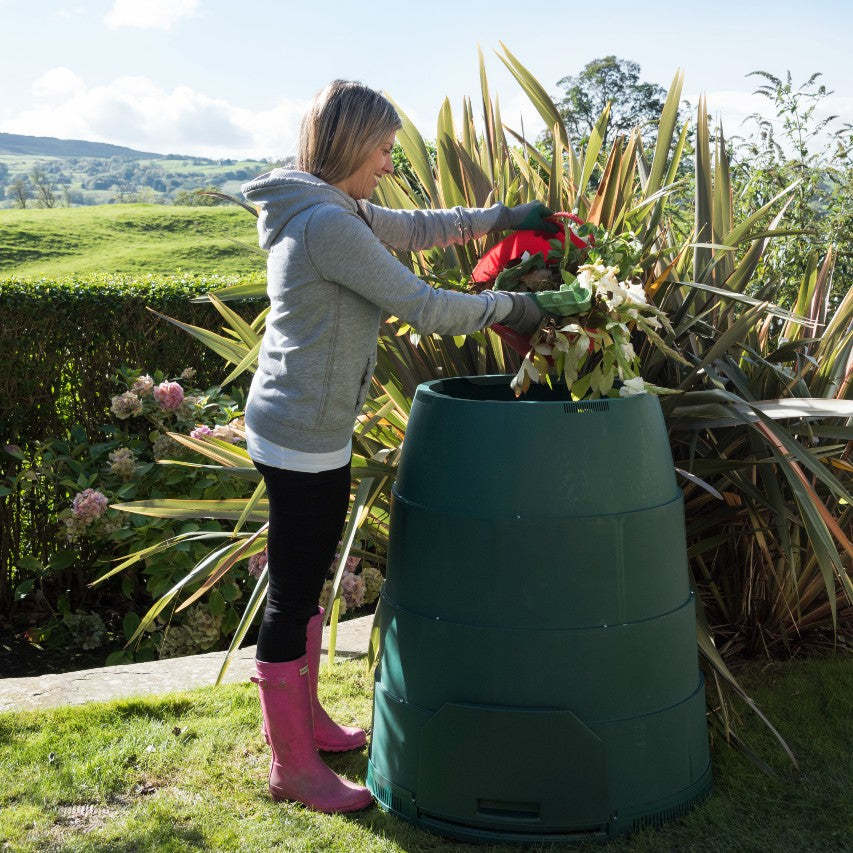 Woman filling Green Johanna compost bin with garden waste