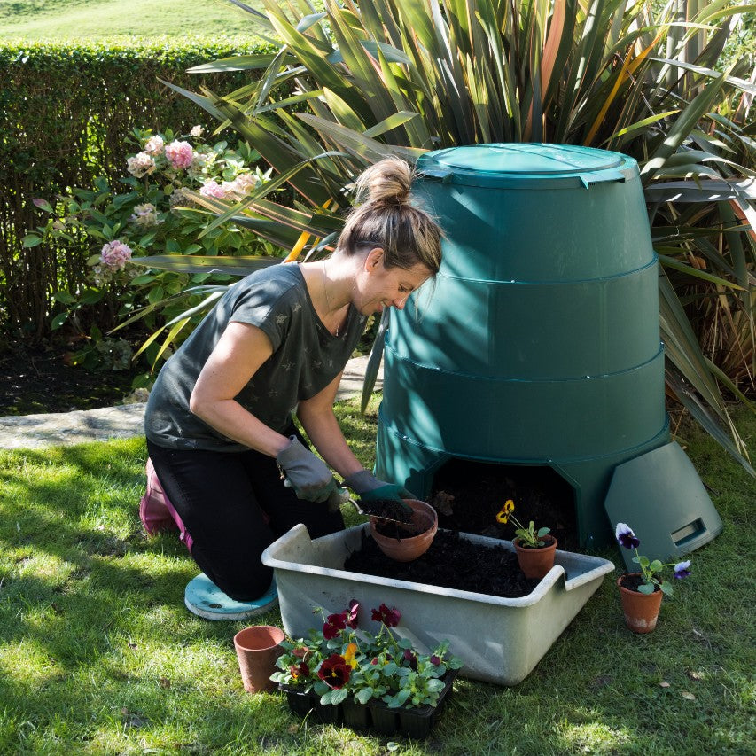 Woman collecting compost from Green Johanna composter